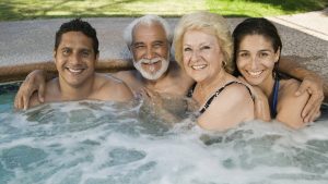 family in backyard spa